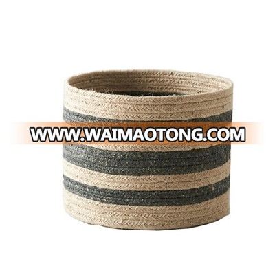 Handmade woven round jute in two-tone stripes pairs with a practical,   jute basket planter